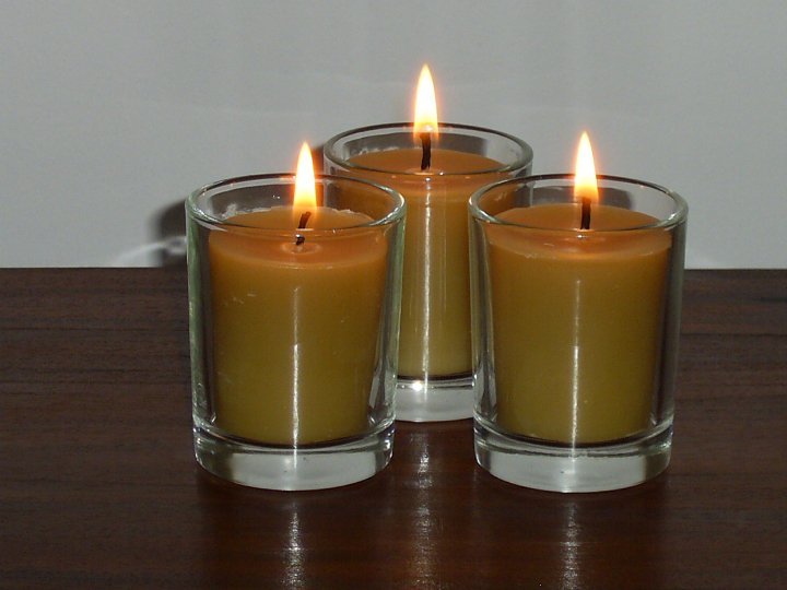 Hand-poured pure Australian beeswax votive candles burning in glass holders on timber — Suz E Bee Candles, Port Stephens NSW